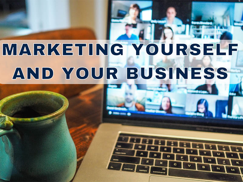 New business owner on Zoom networking meeting with sign Marketing Yourself and Your Business
